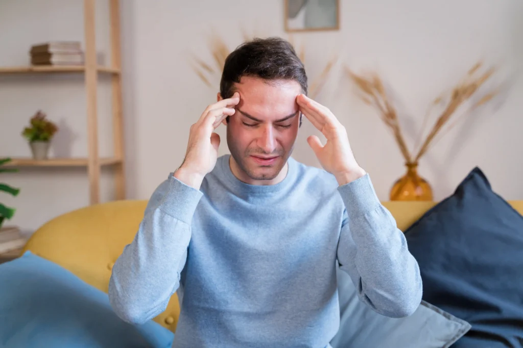 Person experiencing headache after missing a prescribed medication dose
