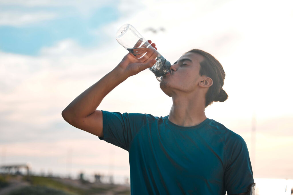 Man drinking water to stay hydrated