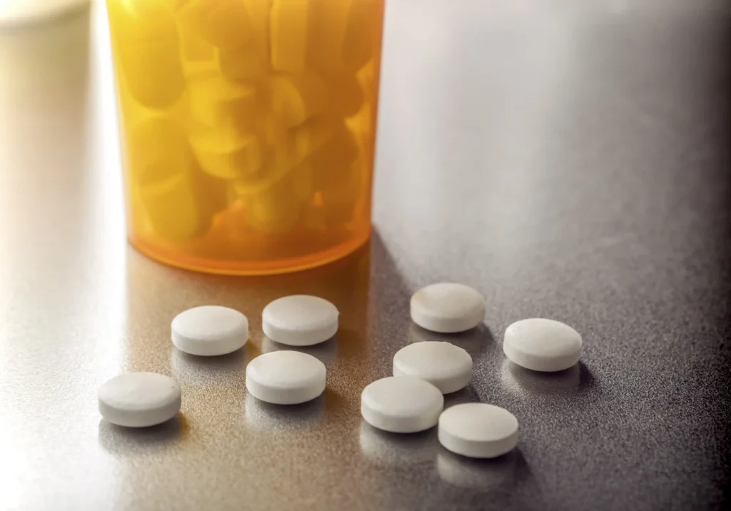 Prescription clonidine medication bottle and tablets on a table