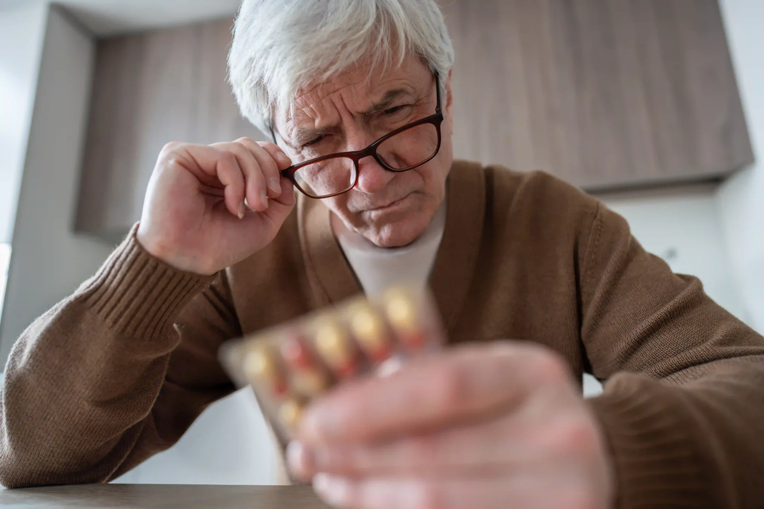 Senior man looking at the missed Levodopa medication