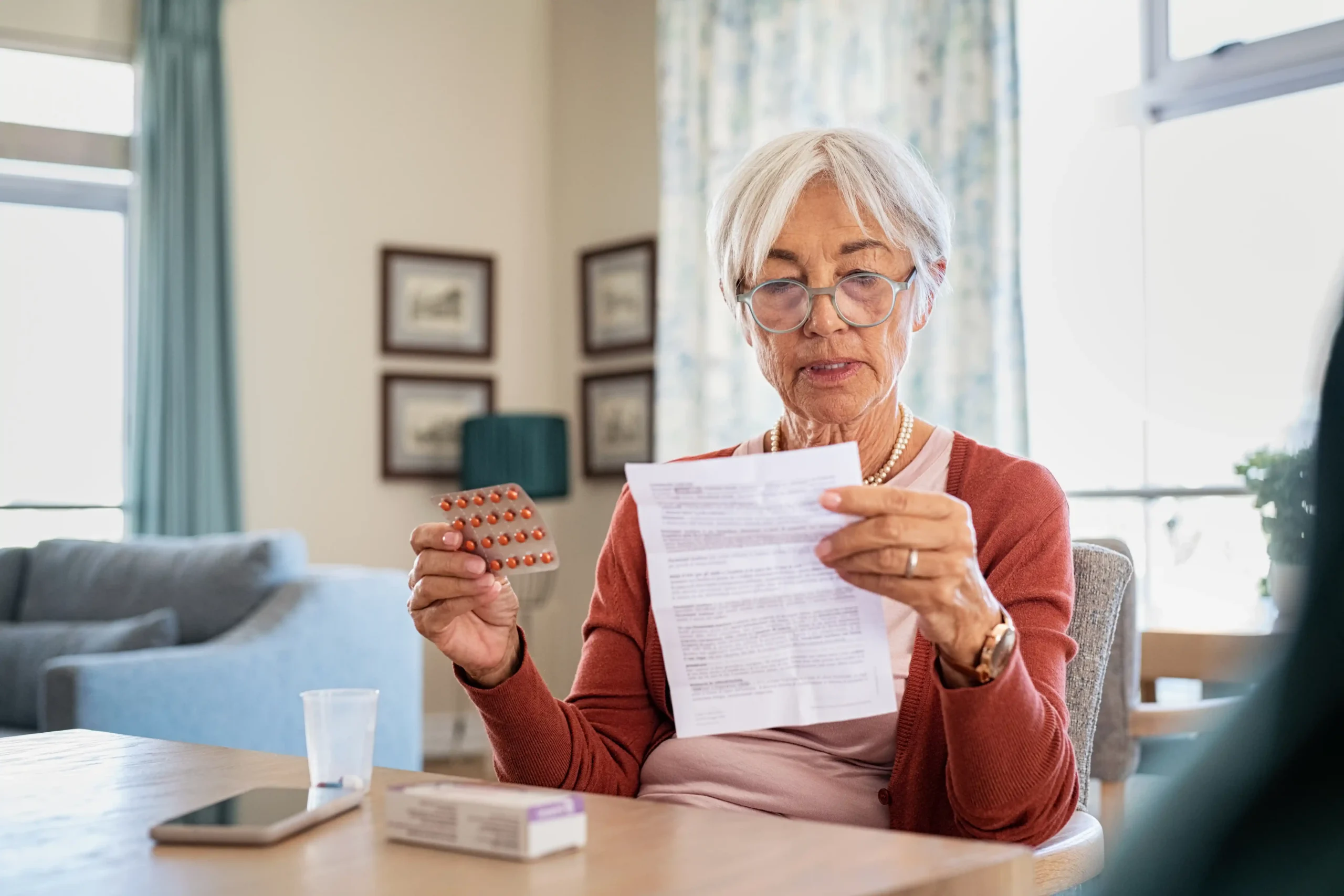 Senior woman checking medication after missing a doxycycline dose
