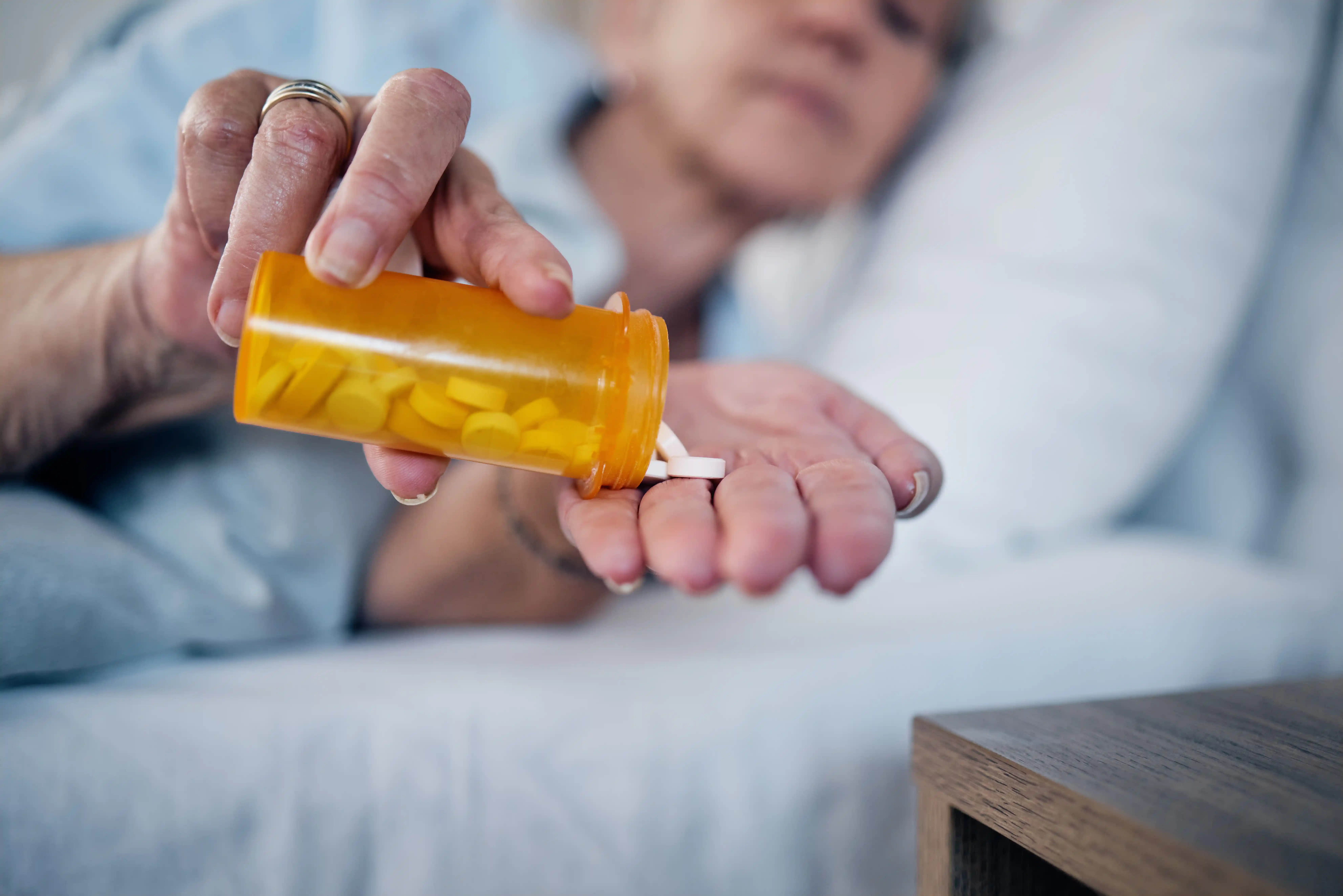 Senior taking flecainide medication at home