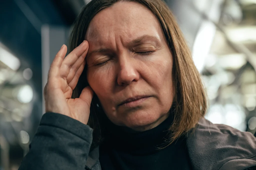 Senior woman experiencing dizziness after missing a dose